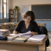 Insegnante corregge i compiti in un’aula vuota dopo le lezioni