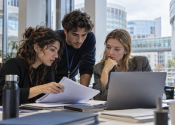 Tre giovani tirocinanti collaborano in un ufficio durante un’esperienza di formazione nelle istituzioni europee